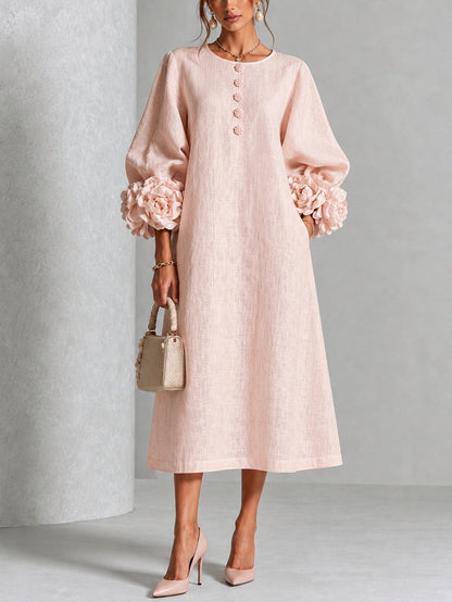Vestido midi rosa con botones frontales y puños florales llamativos