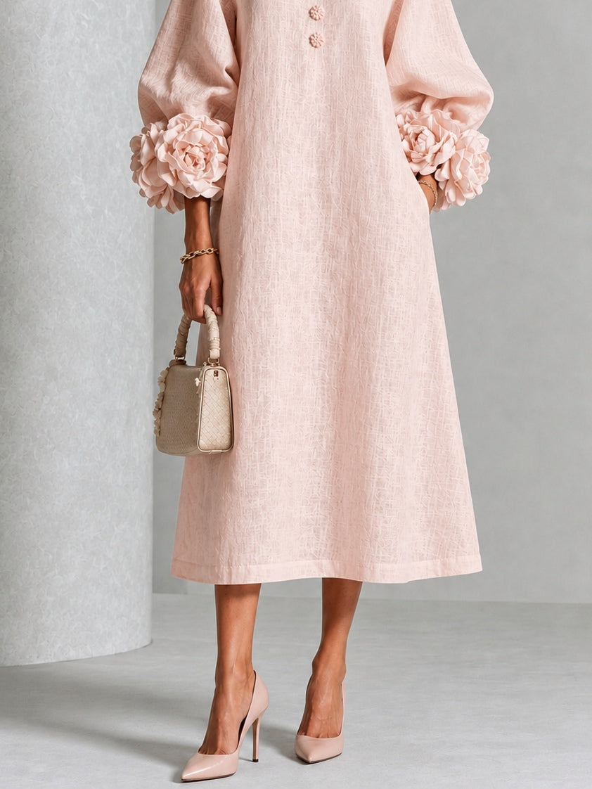 Vestido midi rosa con botones frontales y puños florales llamativos