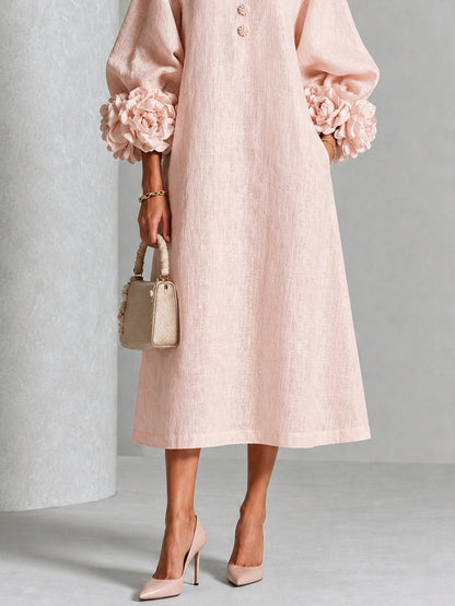 Vestido midi rosa con botones frontales y puños florales llamativos