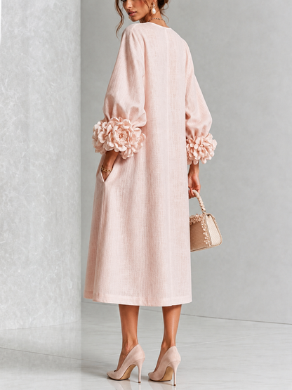 Vestido midi rosa con botones frontales y puños florales llamativos